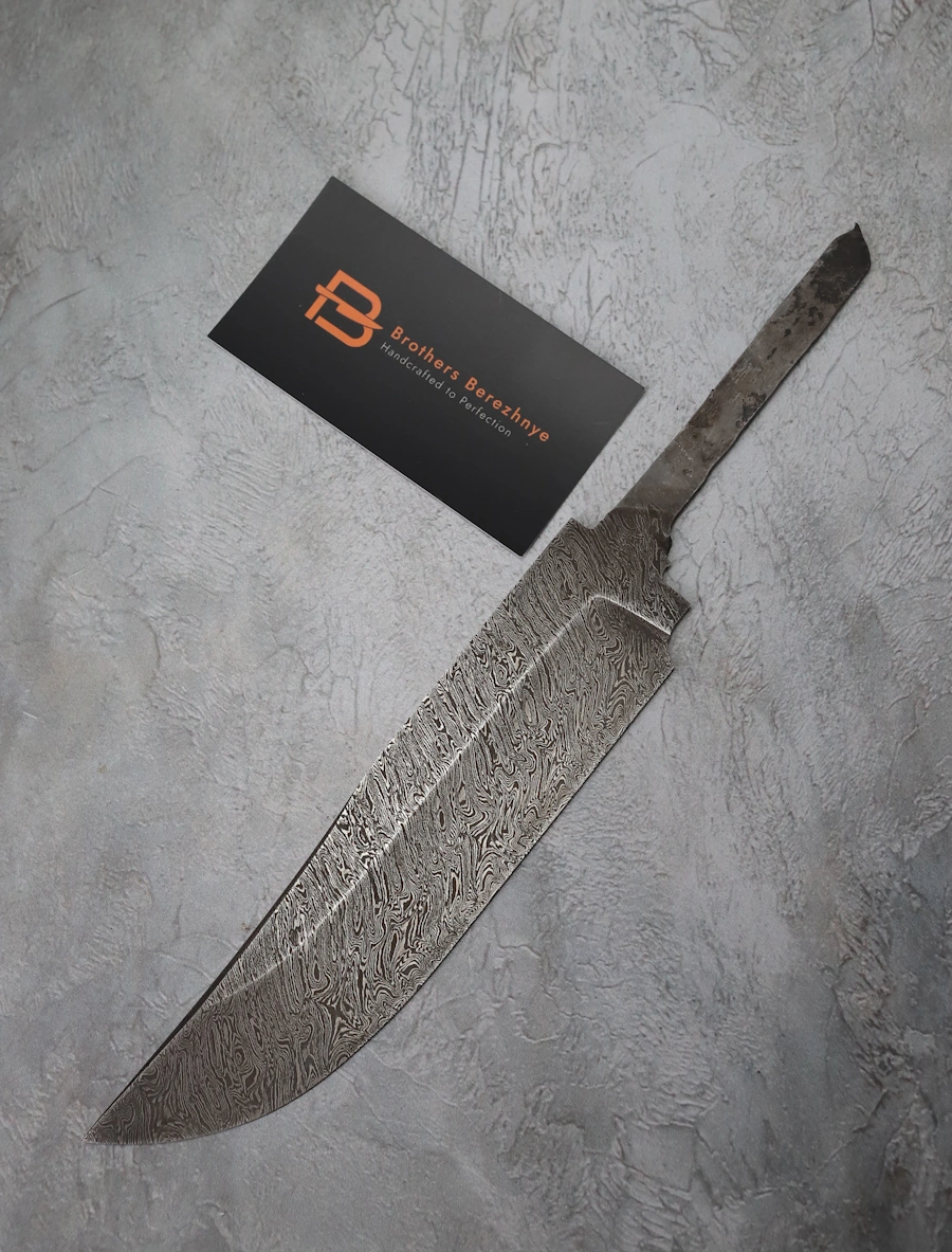 Hand-forged Damascus steel blade made from U8A, ShKh-15, 5KhNMA, and 45 steel – 85 mm length, etched finish Hand-forged Damascus steel blade made from U8A, ShKh-15, 5KhNMA, and 45 steel – 85 mm length, etched finish