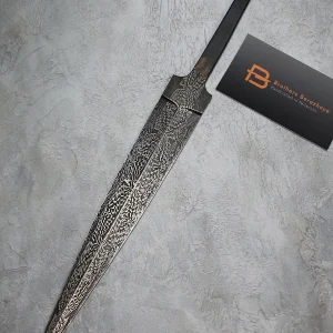 Hand-forged Damascus blade with feather pattern and fullers